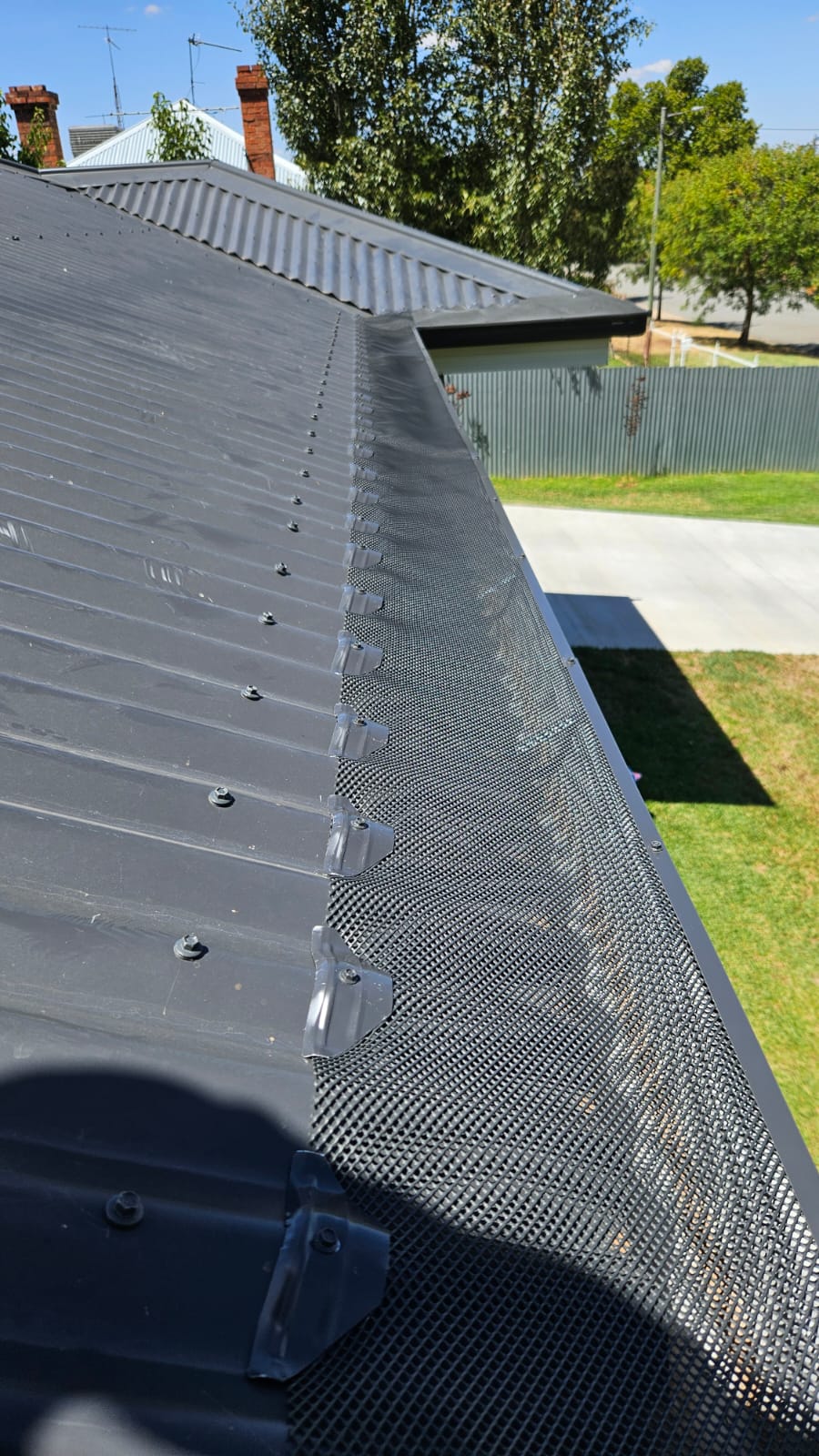 Gutter guard mesh trim installation
